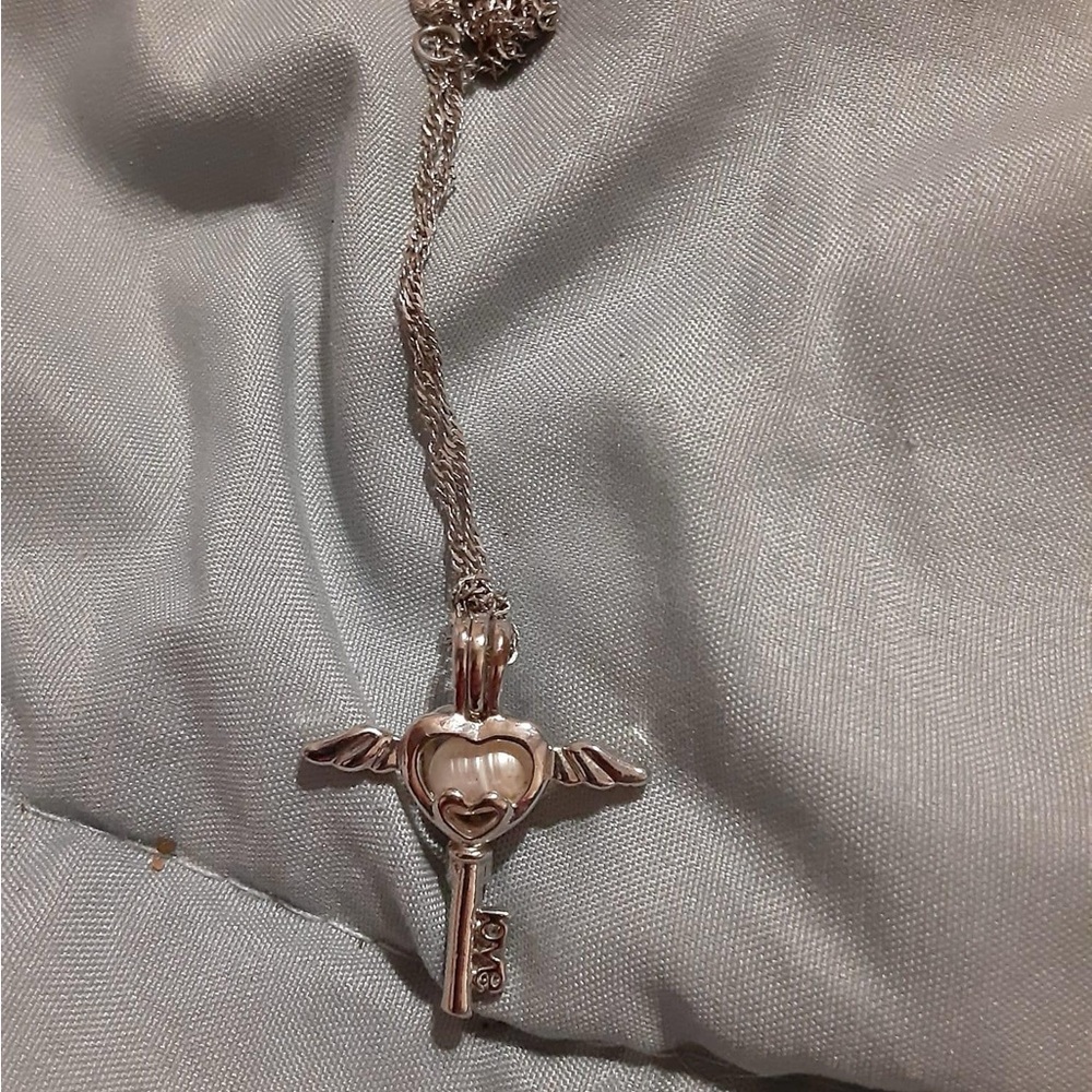 Silver Cross Pendant Necklace with Pearl and Ornate Design